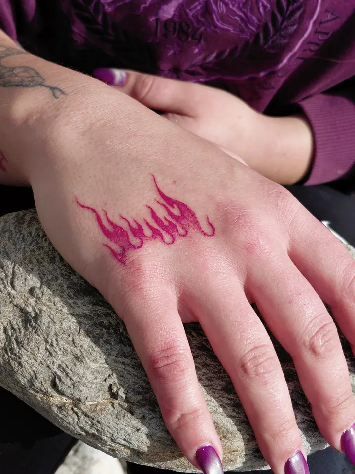 Pink flames on the hand