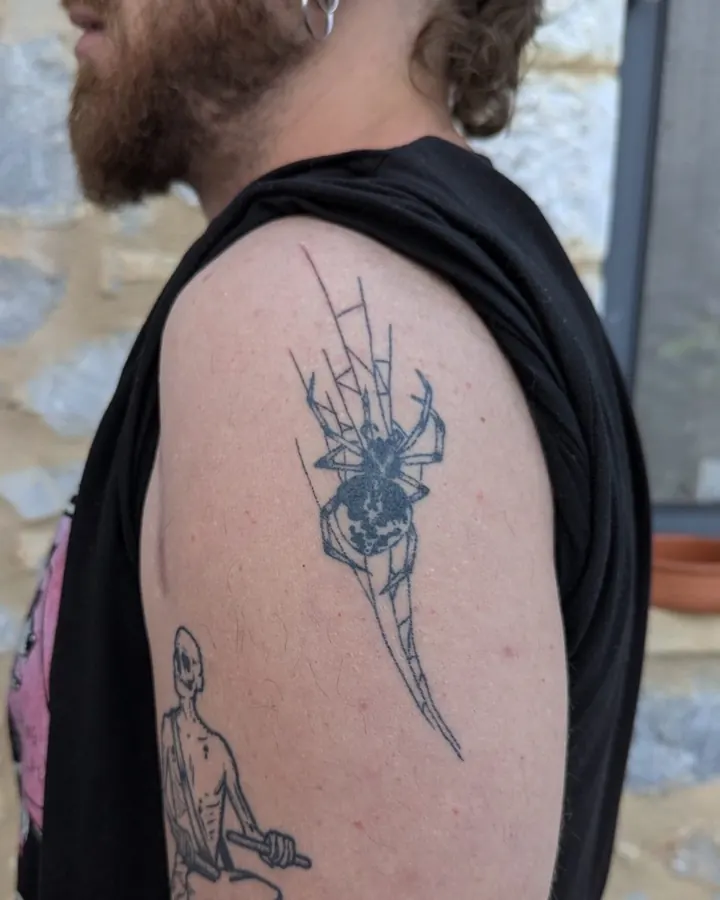 Spider in its web on the shoulder