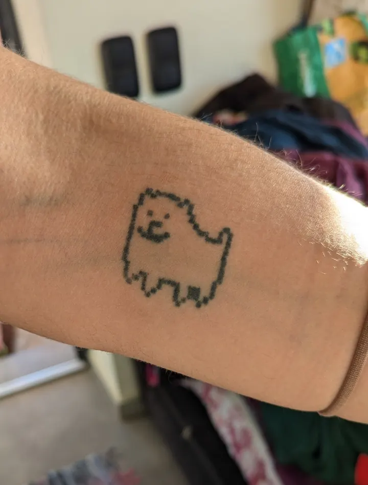 Pixel-art dog on the forearm