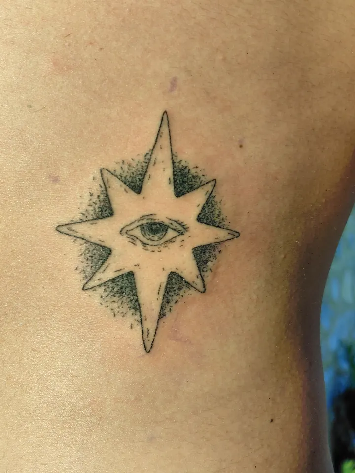 Eight-pointed star with an eye and dotwork shading